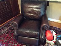 Full view of Bernhardt leather recliner chair in dark brown, showing seat, back and arms with studded decoration.