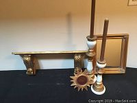 Five piece gold leaf accessory set displayed including shelf with carved supports, candlesticks with candles, framed mirror, and sunburst photo frame.