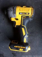 Side view of DEWALT impact driver showing 20V MAX XR logo, pistol grip, battery base (bare tool).