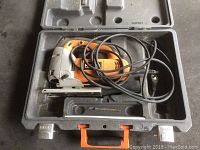 Rigid corded jig saw inside molded hard plastic case with orange handle and included tool compartments.