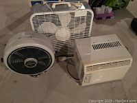 Photo showing all three devices: the Beaumark air conditioner, the Super brand box fan in its original box, and the circular fan with black grill.