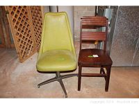 Two chairs side by side on floor showing the green upholstered swivel chair and the wooden chair