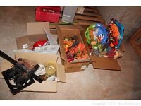 Overview of all items including boxes containing fall faux foliage, Halloween candy bowl with pumpkin details, crucifix, small trinket boxes and valentine decor