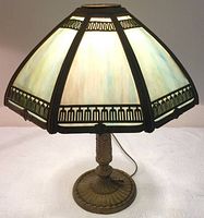Full view of lamp showing multicolor slag glass shade and metal base