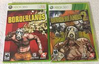 Front cover photo showing original Xbox 360 game cases for Borderlands and Borderlands 2 with respective cover artwork.