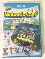 Front cover of Nintendo Land game case for Wii U showing colorful Nintendo characters and Wii U GamePad images