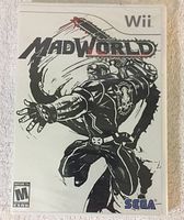 Front cover of Nintendo Wii game MadWorld showing stylized art of character with black, white and red color scheme.