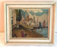 Overall view of the framed oil painting of Middle Eastern seaport with boats and figures