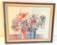 Full framed view of the oil painting showing colorful floral bouquets and signature by Loret.