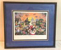 Framed Disney lithograph featuring multiple Disney characters and parks, with visible colorful artwork and black frame.