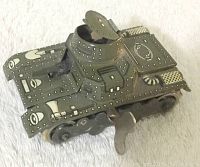 Side angle showing tank body, turret, and wind-up key attached right side