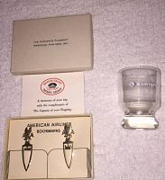 Lot displaying original box with pair of American Airlines bookmarks and Eastern Airlines shot glass on beige towel surface.