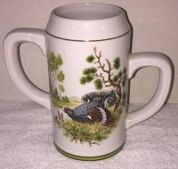 Front view of ceramic stein showing one side pheasant with natural scene.