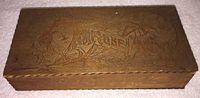 Top view of the rectangular wooden box showing the carved pyrography art and word 'Hose' on the lid.