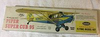 Box front showing illustrated Piper Super Cub 95 model airplane in yellow and blue with markings N9412P, 24 inch wingspan, brand Guillows.