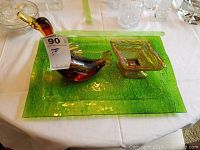 Set showing Murano glass goose and two amber iridescent carnival glass dishes on green glass tray