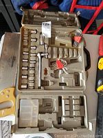 Open socket set in plastic case showing assorted sockets, ratchet wrench, Allen keys