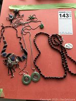 Overview of six jewelry pieces on red background