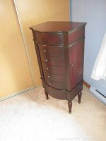 Front view of entire jewelry chest showing drawer configuration and overall shape