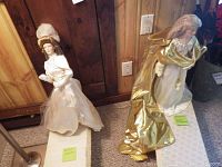 Two dolls shown standing side by side, Gibson Girl on left in white dress and Queen Galadriel on right in white and gold robe.