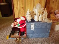 Overview of crystal ice palace, sleighs, plush dolls including Baby Miss Piggy and Santa Claus on carpet background