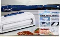 Photo of sealed box showing Rival Seal-A-Meal vacuum food sealer with canister and accessory sealer hose as bonus.