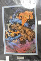 Frontal view of detailed laser cell artwork showing The Fantastic Four characters in action, mounted on mat board with a plaque.