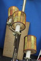 Close-up of two of the lamp's shades showing fabric design and lamp arms.