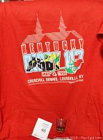 Red vintage Kentucky Derby 117 T-shirt with graphic including steeples, horses, and rose dated May 4, 1991 on Churchill Downs, Louisville, KY.