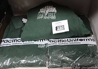 Three green sweatshirts folded and packaged with Oak Tree Racing Association logos, showing they are new old stock.