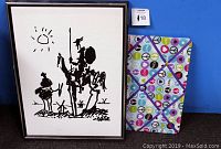 Photo of vintage framed Picasso print and colorful decorative wall picture holder against a blue background.