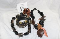 Photo showing four pieces of vintage costume jewelry including necklaces and bracelets with wood, bronze, beads, and resin elements