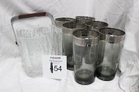 Vintage textured clear glass ice bucket with metal handle and six large smoky gray tinted drinking glasses with silver rims.