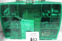 Tackle box closed, showing weights and hooks inside transparent lid compartments.
