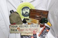 Photo showing collectible Duck Dynasty themed lot items including canteen, frisbee, two wooden signs, painted duck figure, and duck callers.