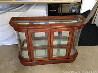 Front view showing two glass doors with wood frame and curved side panels