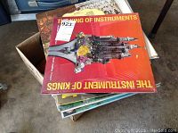 Box with a stack of LP records including The Instrument of Kings with red cover showing castle illustration