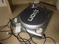Silver ION turntable showing overall condition and connected power cord