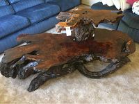 Full view of two-tier burl wood coffee table showing live-edge lower and upper slabs