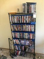 Full view of black metal rack loaded with media cases