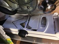 Close-up of white plastic mandolin slicer