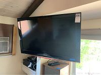 Front view of Samsung 40-inch TV mounted on wall bracket.