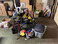 Wide shot showing all items including chairs, fishing rods, bocce balls, backpack, sleeping bag, and other outdoor gear