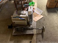 Top view of Sharp air conditioner, metal detector, and tower heater on wood pallet and floor.