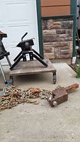 Full view of fifth wheel hitch mount on a rolling platform with chains in front