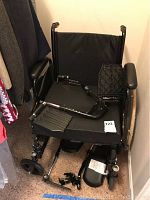 Front view of Tracer SX5 wheelchair showing padded seat with extra seat pad, armrests, and back support.