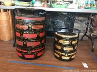 Both Asian wedding baskets side by side on floor showing size difference and design.