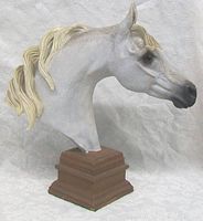 Side view showing the detailed face, mane and base of the horse head bust.