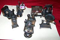 Overview of set of 9 die-cast figural pencil sharpeners, showing various vintage object designs.