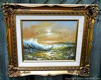Front view of the oil painting with ornate gilt wood frame showing surf tide scene and artist signature.